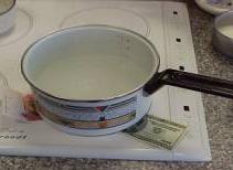 pan heating on induction element with unburned dollar bill under it